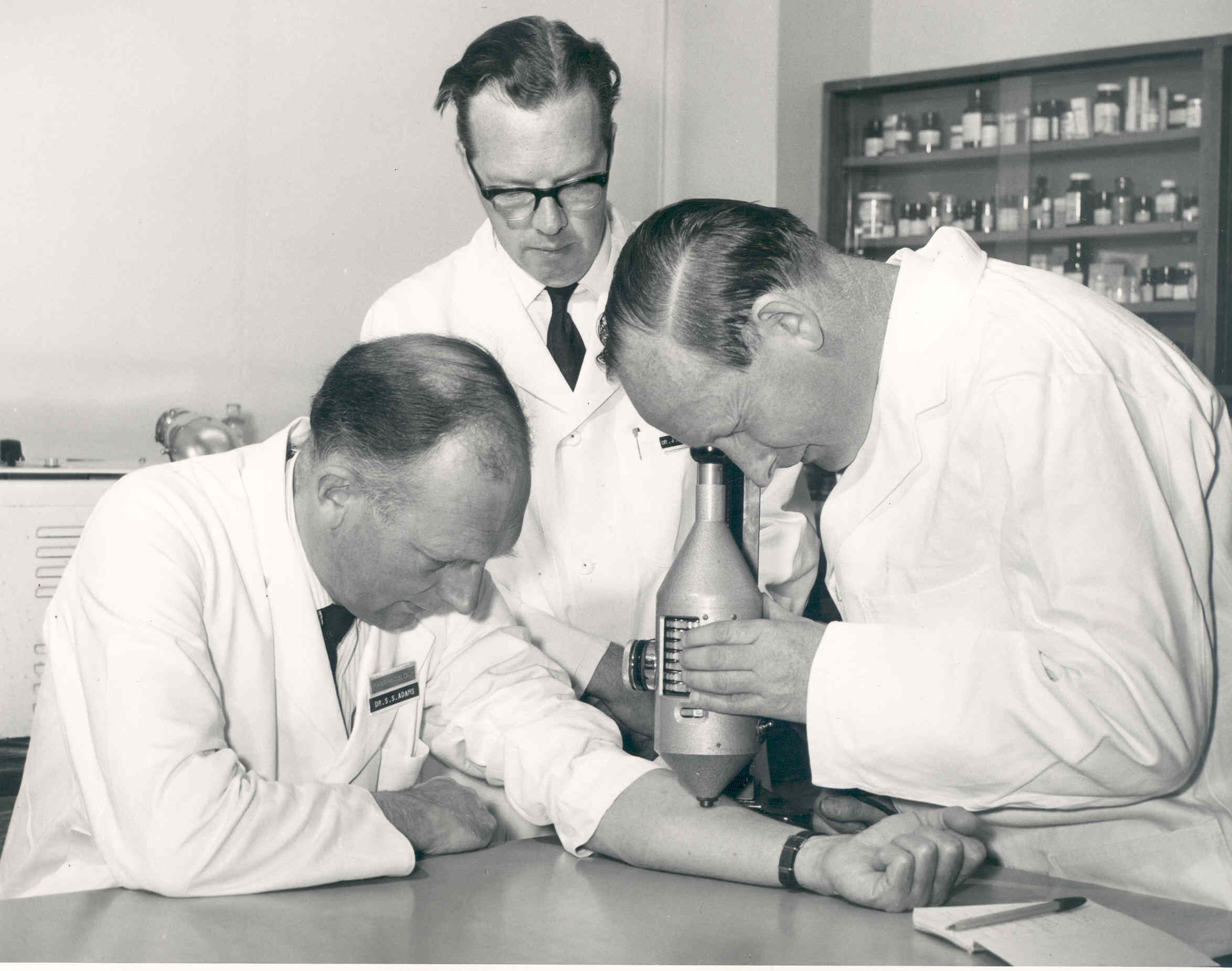 Dr Stewart Adams, Dr John Nicholson and Mr R Cobb studying degrees of inflammation using a colour intensity measuring device.